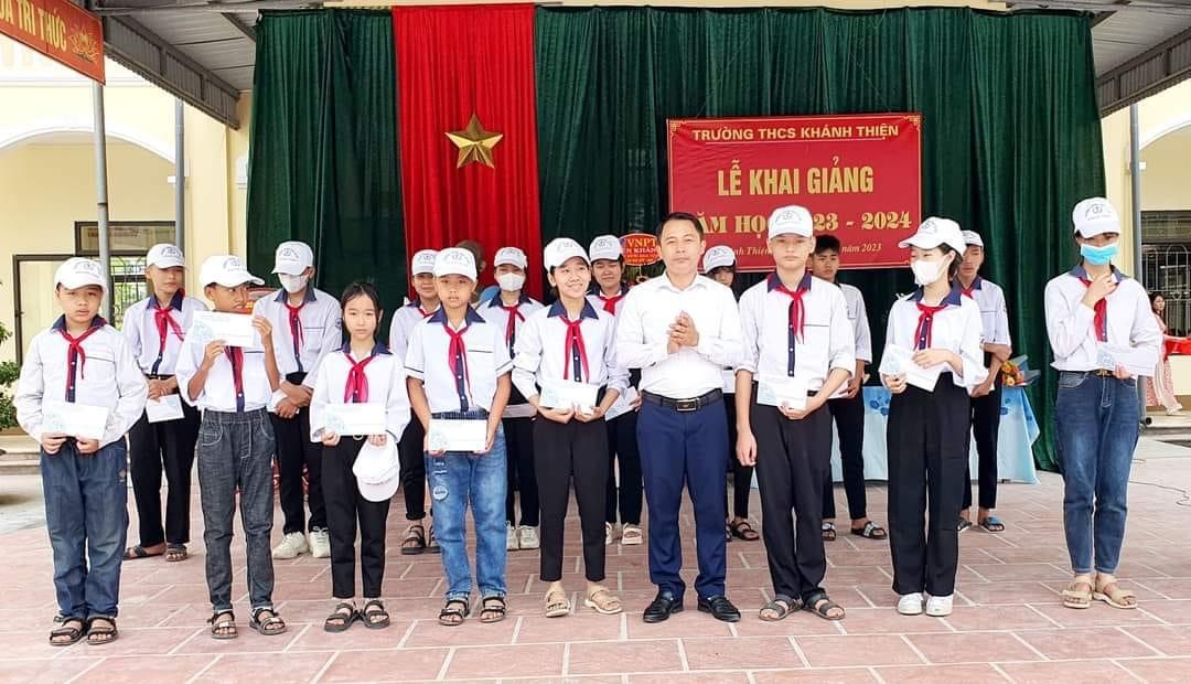 Đồng chí Nguyễn Thế Quang - HUV, Bí thư Đảng bộ xã trao quà cho các em học sinh có hoàn cảnh đặc biệt khó khăn nhân dịp khai giảng năm học mới tại Trường THCS xã nhà